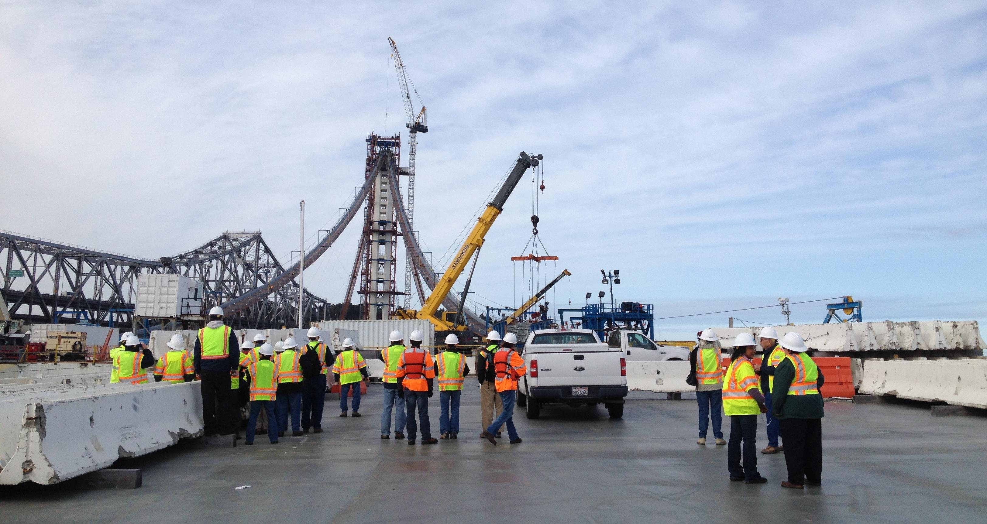 A group of retirees standing on the new Bay Bridge while it was under construction